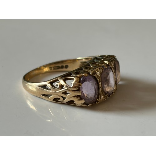 19 - An amethyst three stone ring, the three oval amethysts in 9ct gold mount -