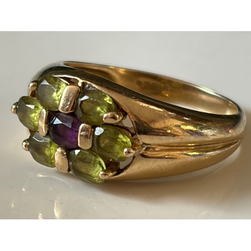 20 - A peridot and amethyst dress ring, of oval cluster design, set in 9ct gold -