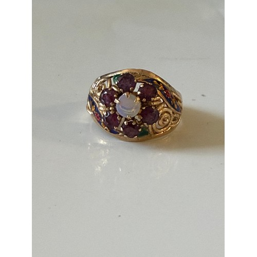 28 - A continental dress ring, set with an opal and garnet cluster with enamel highlights, stamped 14 -