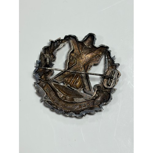 35 - A regimental silver cap badge, for the Queens Own Cameron Highlanders -