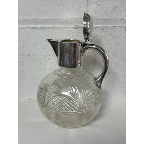 47 - A late Victorian silver claret jug, London 1898, with hinged cover and cut glass body -