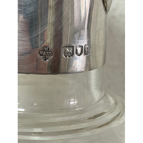 47 - A late Victorian silver claret jug, London 1898, with hinged cover and cut glass body -
