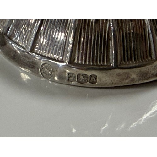 56 - An Elizabeth II silver caddy spoon, Sheffield 1964, of jockey cap design -