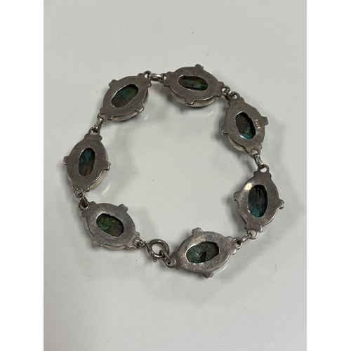 23 - A silver bracelet, set with oval turquoise  coloured stones and a rhodochrosite set silver ring -