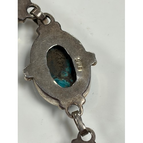23 - A silver bracelet, set with oval turquoise  coloured stones and a rhodochrosite set silver ring -