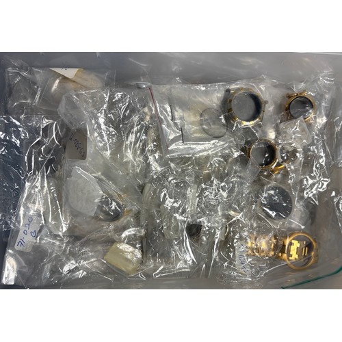 26 - A box of unused watch parts -