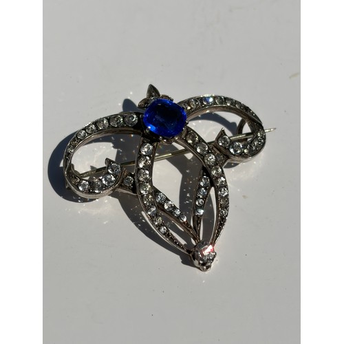 46 - A clear and blue paste brooch, together with a silver brooch and other items -
