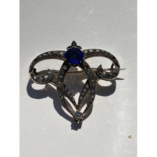 46 - A clear and blue paste brooch, together with a silver brooch and other items -