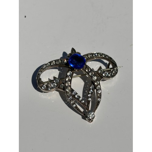 46 - A clear and blue paste brooch, together with a silver brooch and other items -