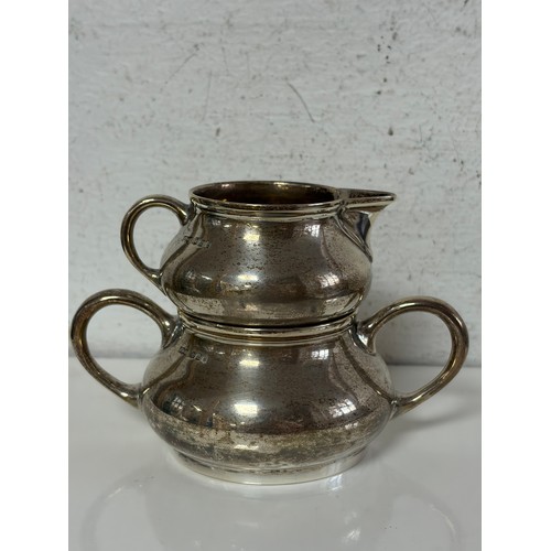 55 - A George V silver cream jug, and matching sugar bowl, Sheffield 1922 -