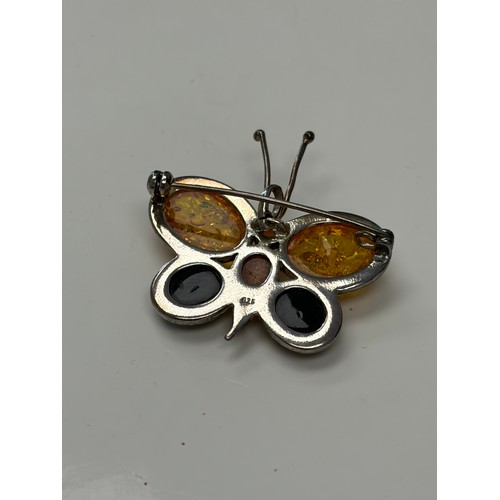 48 - A silver and amber set butterfly brooch -