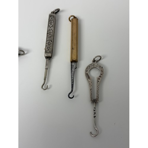 58 - A collection of glove hooks, to include two folding silver and mother-of-pearl examples, a Gorham st... 