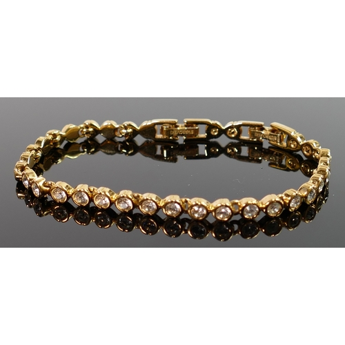 418 - Swarovski gold plated tennis bracelet: set with diamond style stones.