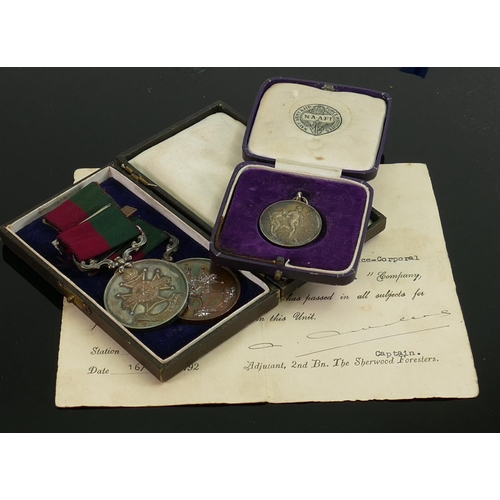 1538 - A collection of military and sporting medals: To include 1933 football medal awarded to 4969817 Lanc... 