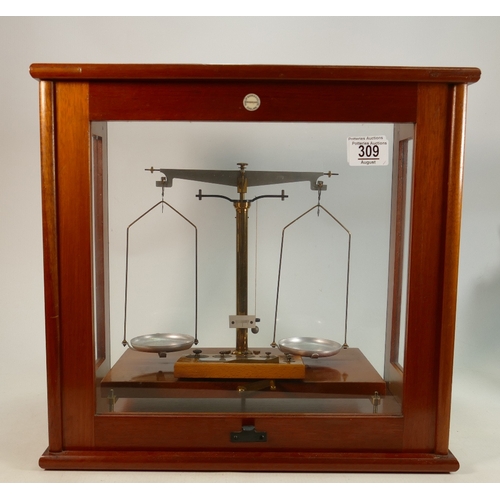 309 - Philip Harris mahogany cased scientific balance: Complete with weights, 42cm wide.