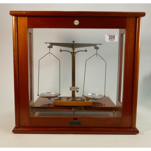 309 - Philip Harris mahogany cased scientific balance: Complete with weights, 42cm wide.