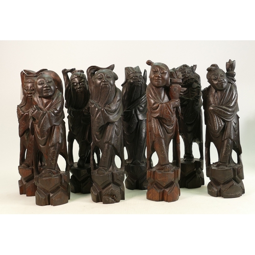 99 - Eight carved wooden Chinese figures of Immortals: All inlaid with pewter or similar metal.  Some min... 