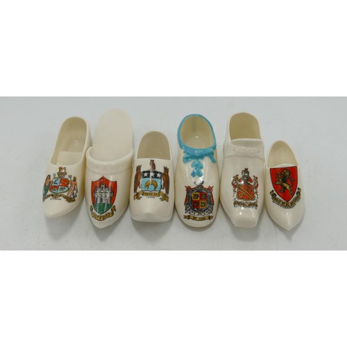 413 - A collection of W. H Goss crested shoes: Including The Queen Victoria Slipper, a faithful reproducti... 