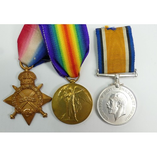 657 - A group of medals awarded to Gnr T.W.Bailey R.G.A: Three first world war medals together with photog... 