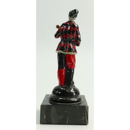 660 - Good porcelain figure of a masked harlequin: Playing a banjo, mounted on marble plinth, height 19cm.