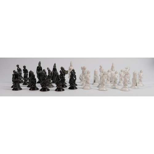 701 - Austrian glazed pottery chess set: Restoration noted to white knight, height of tallest 8cm.