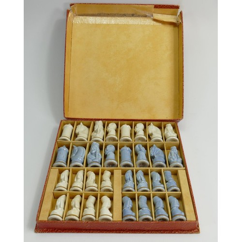 704 - A 20th century porcelain Limoges chess set: Boxed, height of King 7cm.