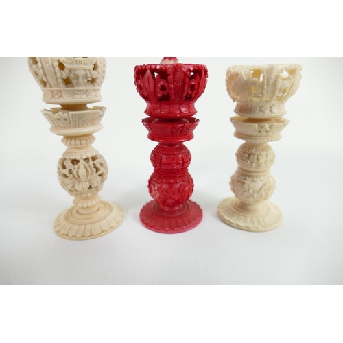 509 - A collection of early Bone Chess Pieces: tallest 9cm,damaged crown on white & top pommel of red crow... 