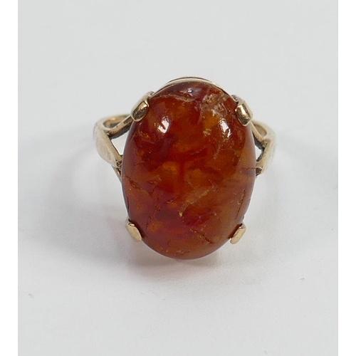 605 - 9ct gold ladies dress ring set with oval orange stone; size K/L,3.7g.