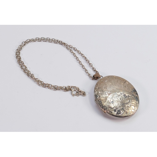 606 - Silver oval locket and chain, 34.8g: