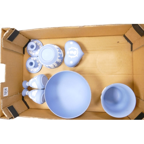 1014 - A collection of Blue Wedgwood Jasperware to include: footed bowl, vases, lidded boxes, candlesticks ... 