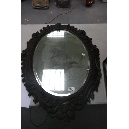 796 - Oak carved framed bevel mirror: 88cm x 62.5cm