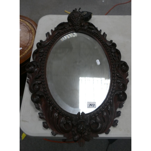 797 - Oak carved framed bevel mirror: 74cm x 51cm