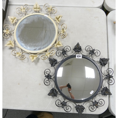 859 - Two circular metal framed mirrors: decorated with leaves. 45.5cm diameter