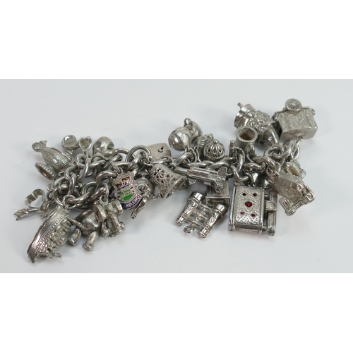 645 - Sterling silver charm bracelet with 23 charms: a number of these charms are marked as silver in some... 