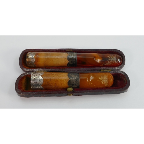 702 - Two amber  Meerschaum and silver mounted cigar or cigarette holders: One in original case, largest m... 