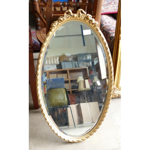 780f - Gilt Effect Ribbon Topped Oval Wall Mirror: height 74cm