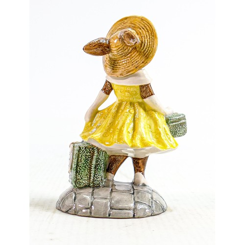 243 - Royal Doulton prototype figure Mrs Bunnykins: With travel cases in yellow dress, height 9cm