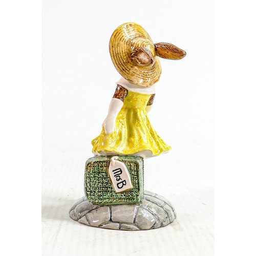 243 - Royal Doulton prototype figure Mrs Bunnykins: With travel cases in yellow dress, height 9cm