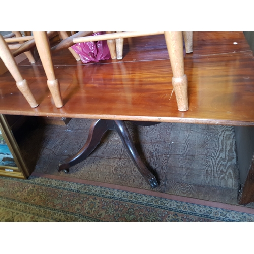 732 - Early 20th century mahogany pedestal dining table with lion paw feet, on castors.