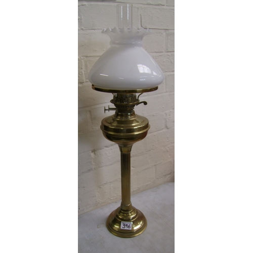 396 - Brass oil lamp with column support, complete with chimney and white glass shade.