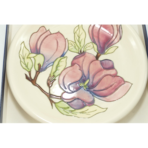 371 - Moorcroft Pink Magnolia on Cream Ground Boxed  Plate, diameter of frame 26.5cm, silver lined seconds