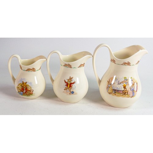 53 - Royal Doulton Bunnykins graduated collection of Albion jugs, tallest 15cm. (3)