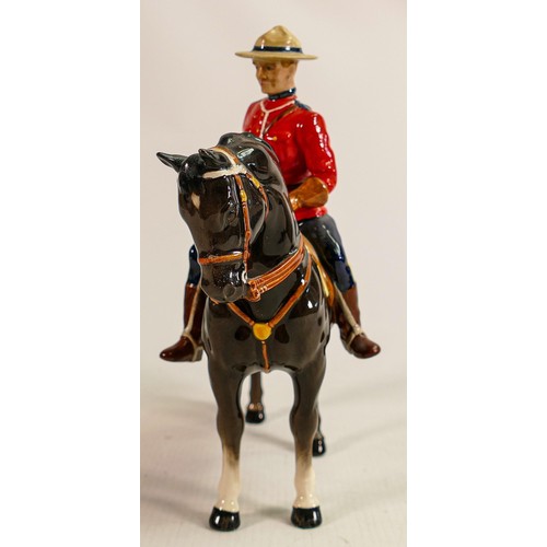 220 - Beswick Canadian Mountie policeman on charcoal horse 1375, restored horses ear & riders boot.