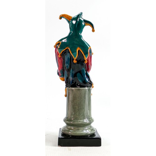 274 - Royal Doulton prototype earthenware figure of a Jester painted in a green, red and orange colourway,... 