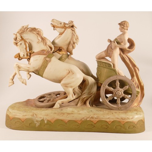 697 - A Royal Dux porcelain figure group, early 20th century, modelled as a classical youth riding a chari... 