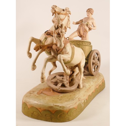 697 - A Royal Dux porcelain figure group, early 20th century, modelled as a classical youth riding a chari... 