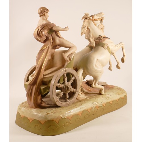 697 - A Royal Dux porcelain figure group, early 20th century, modelled as a classical youth riding a chari... 