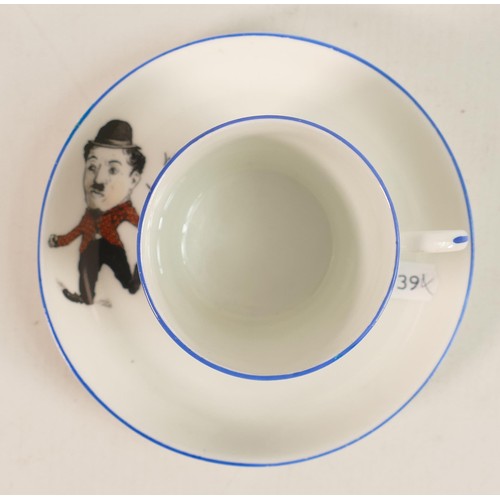 700 - Paragon China unusual cup & saucer decorated with comical Charlie Chaplin. (2)