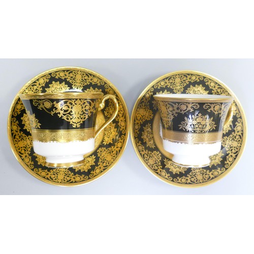 1005 - De Lamerie Fine Bone China heavily gilded Black Exotic Garden patterned cup & saucer sets, specially... 