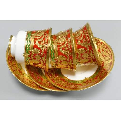 1010 - De Lamerie Fine Bone China heavily gilded Red/ Green Empress patterned cup / saucer sets, specially ... 